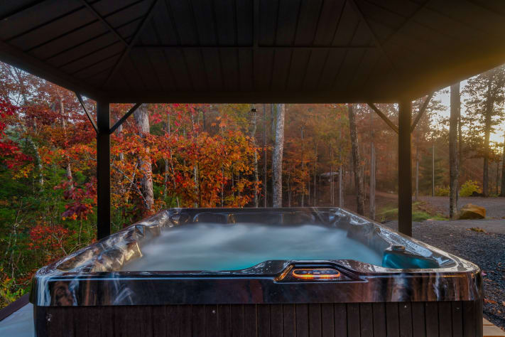 Soak away the day in the private hot tub, tucked beneath the trees with front-row… Sevierville, Tennessee Cabin Rental - Gallery Image #2