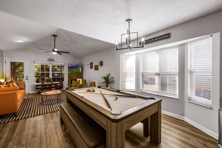 Bright game room with a pool table, cozy seating, and large windows for natural… Pigeon Forge, Tennessee Cabin Rental - Gallery Image #33