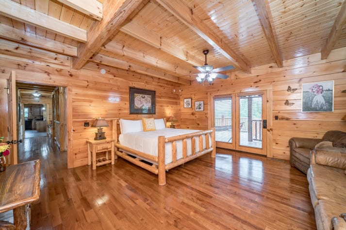 Main floor king bedroom with tv, couch area, and full bathroom Pigeon Forge, Tennessee Cabin Rental - Gallery Image #20