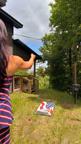 Cornhole and outdoor games included — a flat yard just off the porch. Douglas Lake, Tennessee Cabin Rental - Gallery Image #26