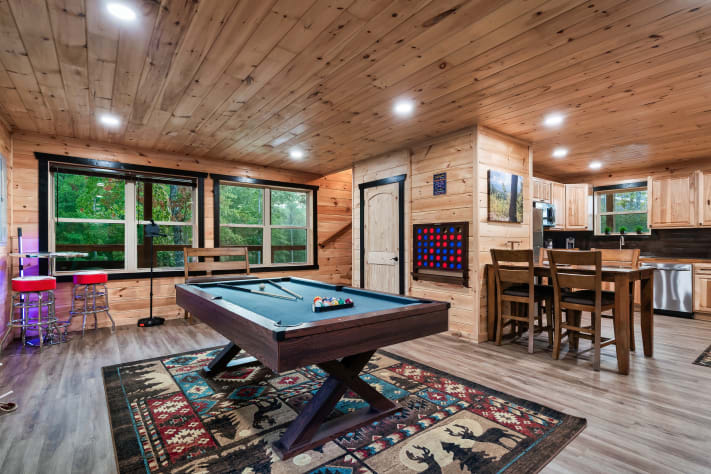 Both the pool table and Connect 4 sit steps from the first-floor kitchen — perfect… Sevierville, Tennessee Cabin Rental - Gallery Image #11