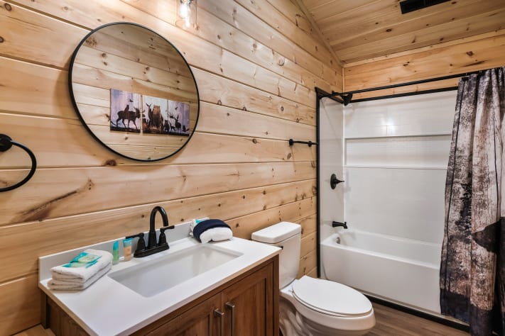 The spacious third-floor full bath offers a deep soaking tub/shower combo, generous… Sevierville, Tennessee Cabin Rental - Gallery Image #29