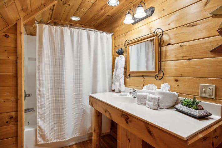 The 3rd-floor ensuite full bathroom offers a vanity and tub/shower combo Sevierville, Tennessee Cabin Rental - Gallery Image #29