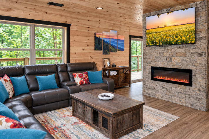 Comfortable seating, a fireplace, and a Smart TV make this living room the perfect… Sevierville, Tennessee Cabin Rental - Gallery Image #10