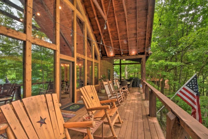 Upper deck seating area complete with rocking chairs, sofa seating area with propane… Nantahala Lake, North Carolina Cabin Rental - Gallery Image #1