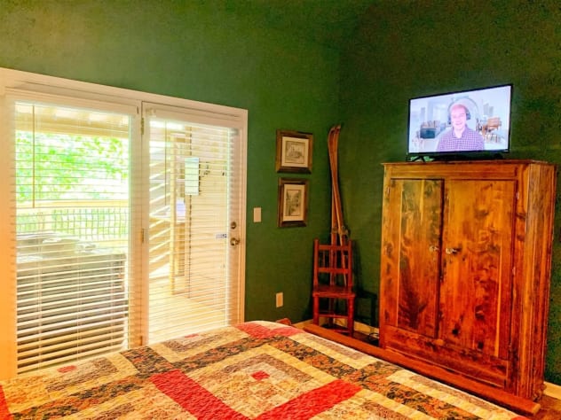 Master King bedroom with doors to get to the hot tub Sevierville, Tennessee Cabin Rental - Gallery Image #13