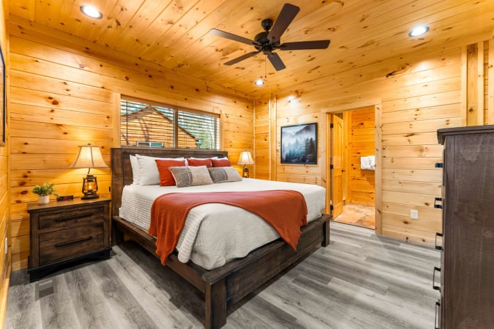 Charming Bedroom: Wake up in a rustic retreat with natural wood accents and a luxurious… Gatlinburg, Tennessee Cabin Rental - Gallery Image #5