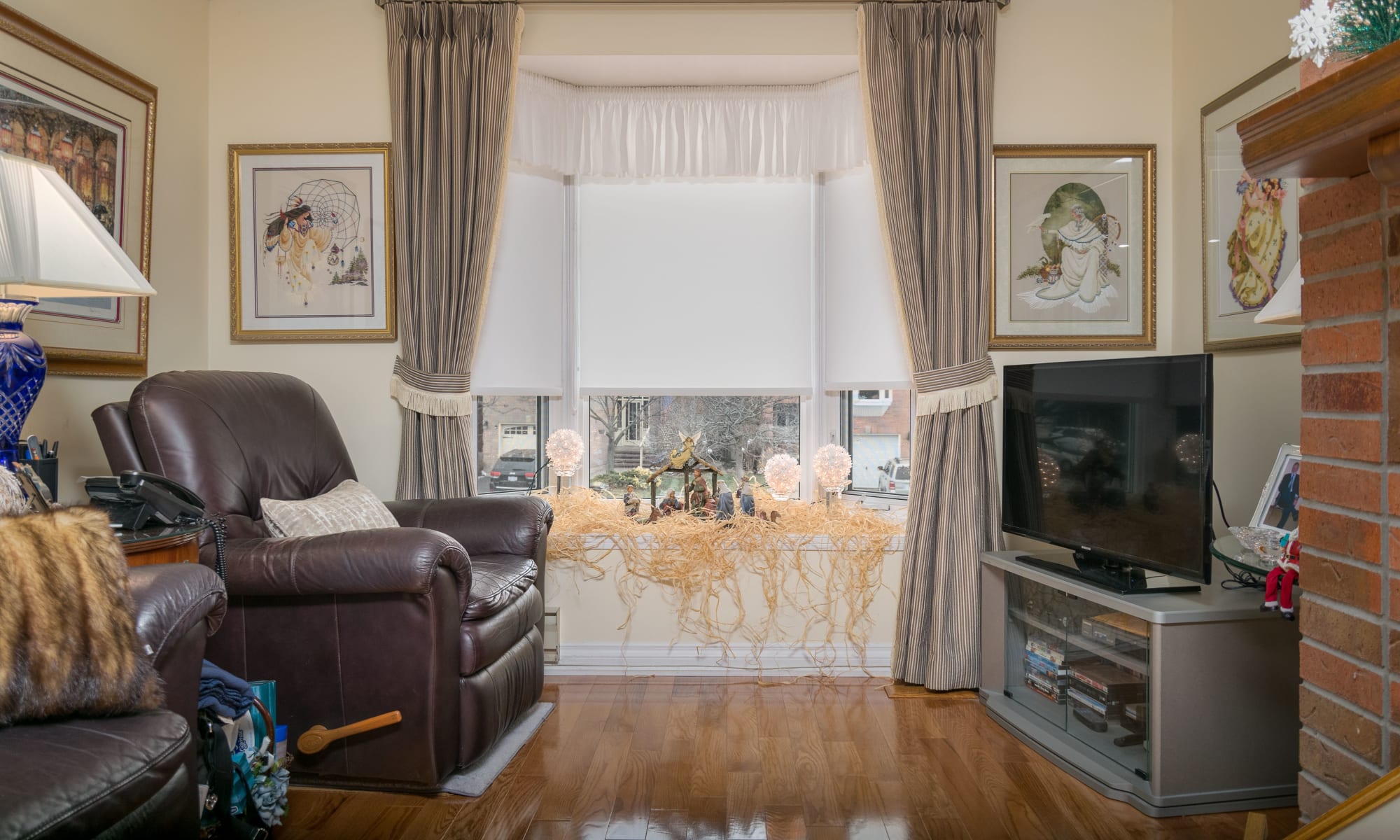 Beautiful side panels and light-filtering blinds, perfectly tie together this comfortable family room