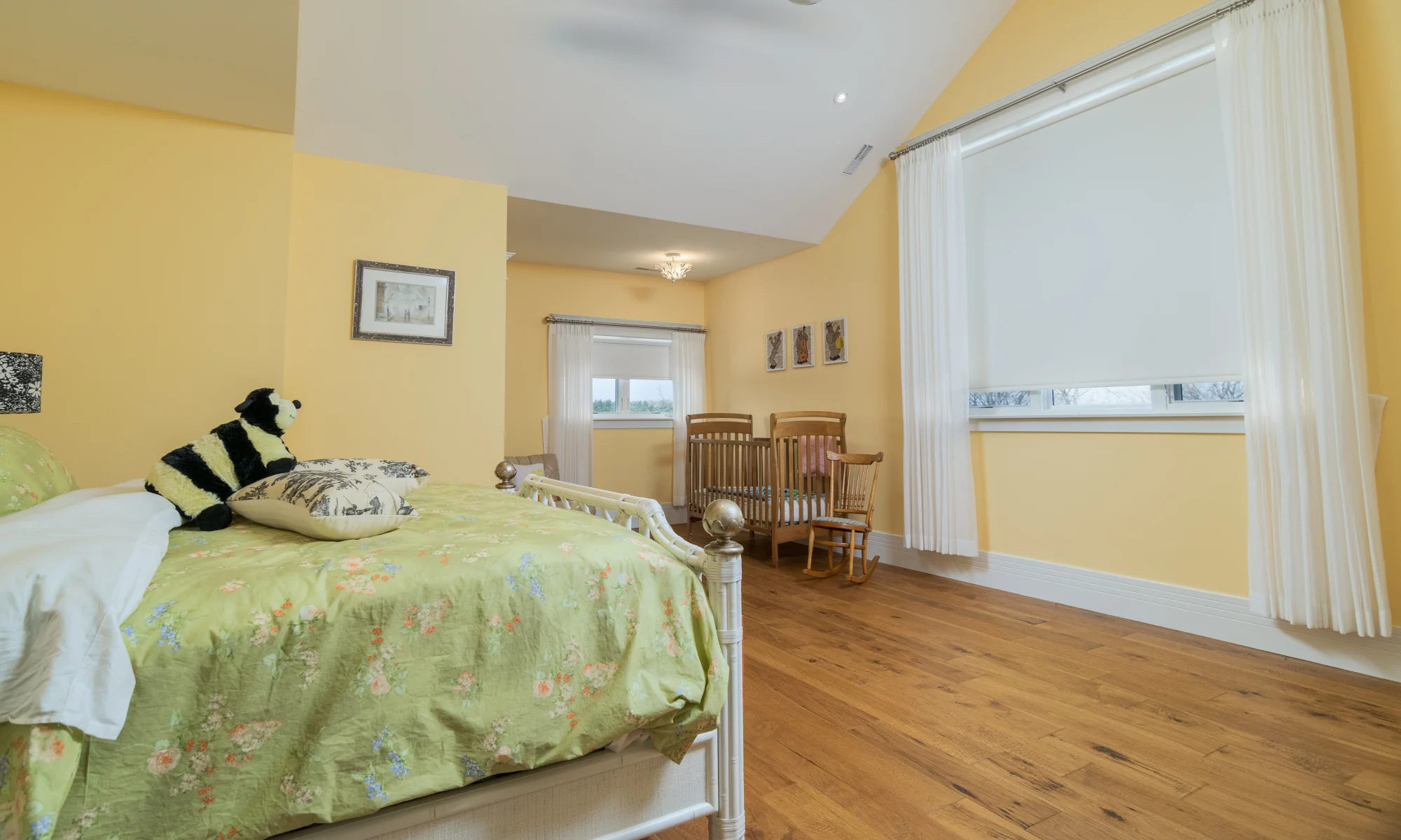 Nursery has blackout blinds, sheers mounted on decorator rods.