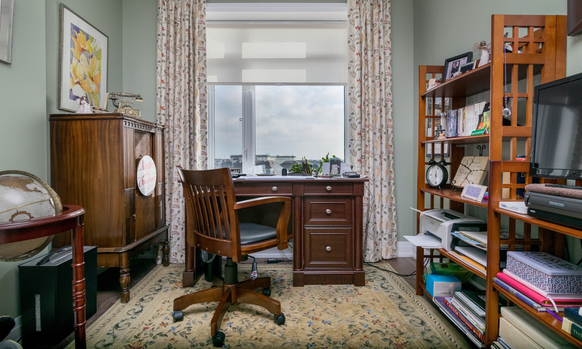 A functional home office with custom drapes. Side panels and filtering rollers blind underneath.