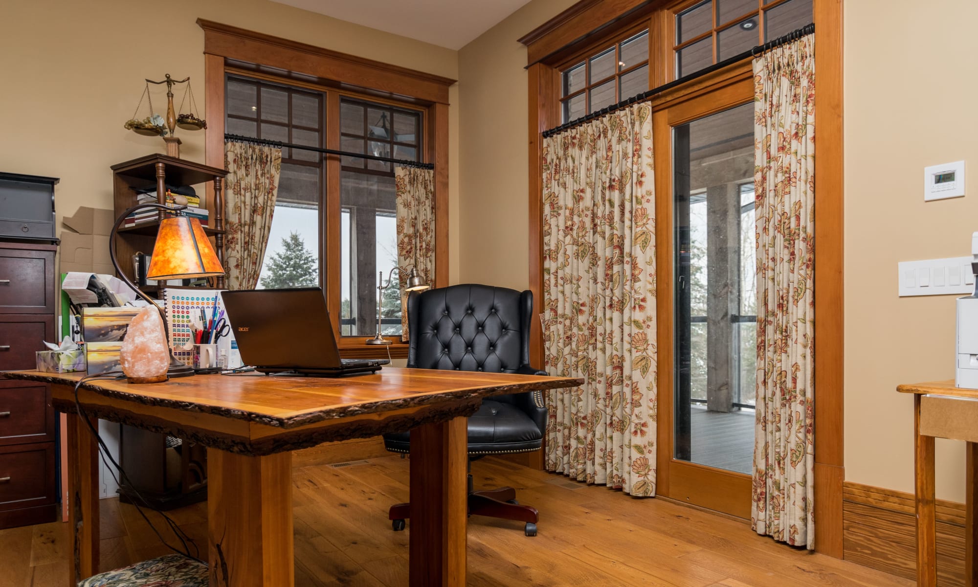 Gorgeous floral printed drapes add a lot of interest to this home office