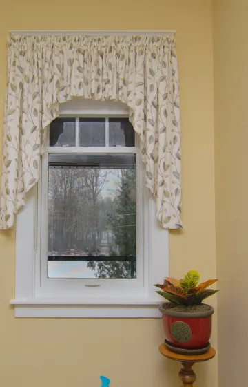 Elegant Bathroom with a gathered, shaped rod pocket valance in a nice fresh leaf pattern.