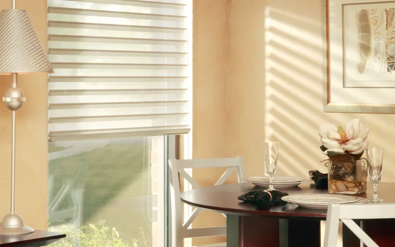sunset shades, half way drawn, and light filtering an elegant eating area