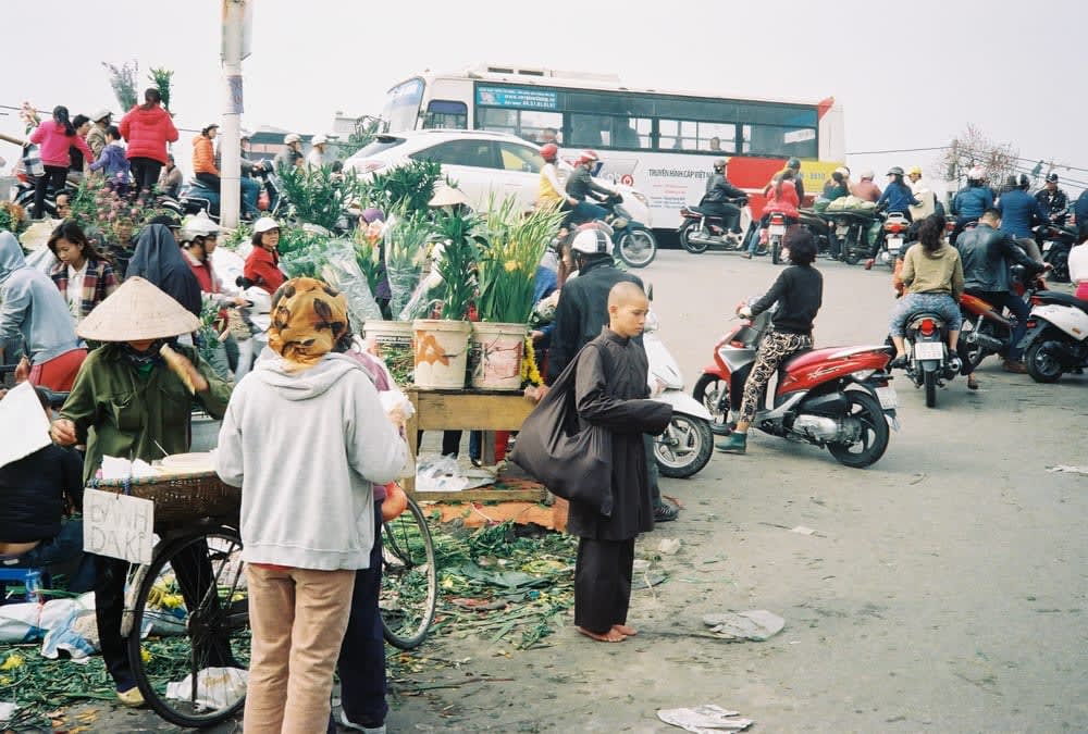 monk standing at flower market