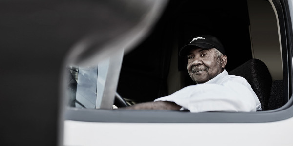 Truck Driver Sitting in His Truck Smiling