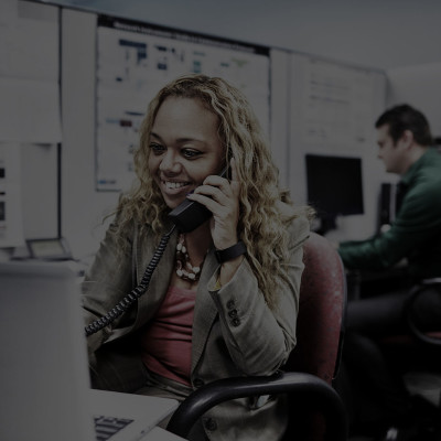 Employee at her desk talking on the phone