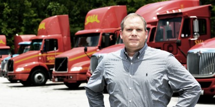 Man standing in front of trucks
