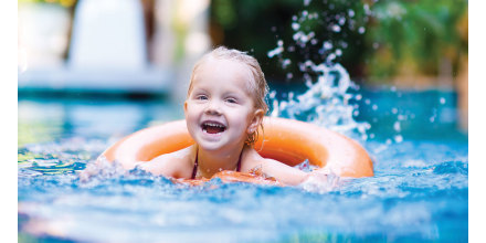 Child swimming with inner tube