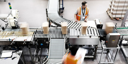 Warehouse worker on picking and packing line