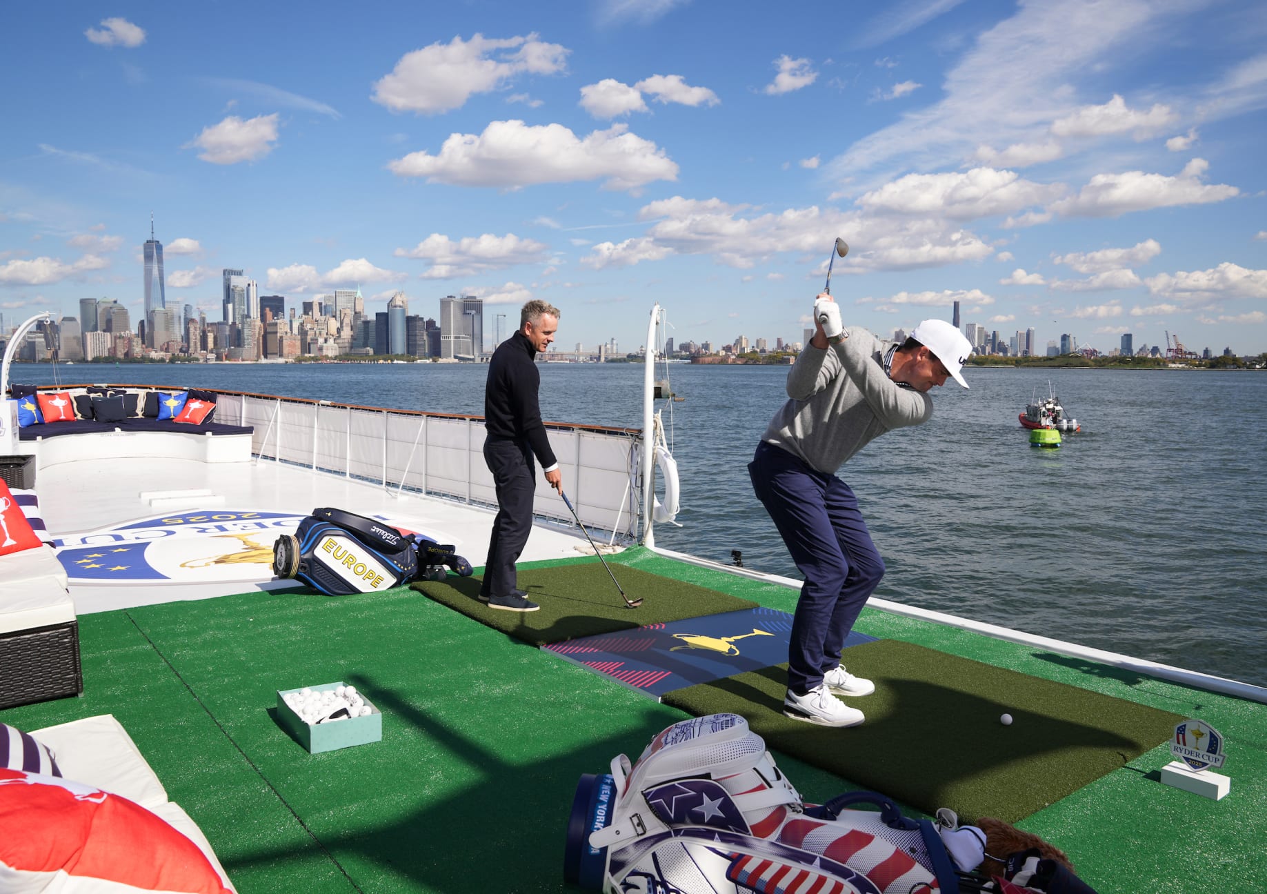 NEW YORK CITY, NY - OCTOBER 08: Captain, Luke Donald of team Europe and Captain, Keegan Bradley of team USA hit golf balls into the water on the boat cruise during the Ryder Cup Year to Go on Tuesday, October 8, 2024 in New York City, New York. (Photo by Darren Carroll/PGA of America)