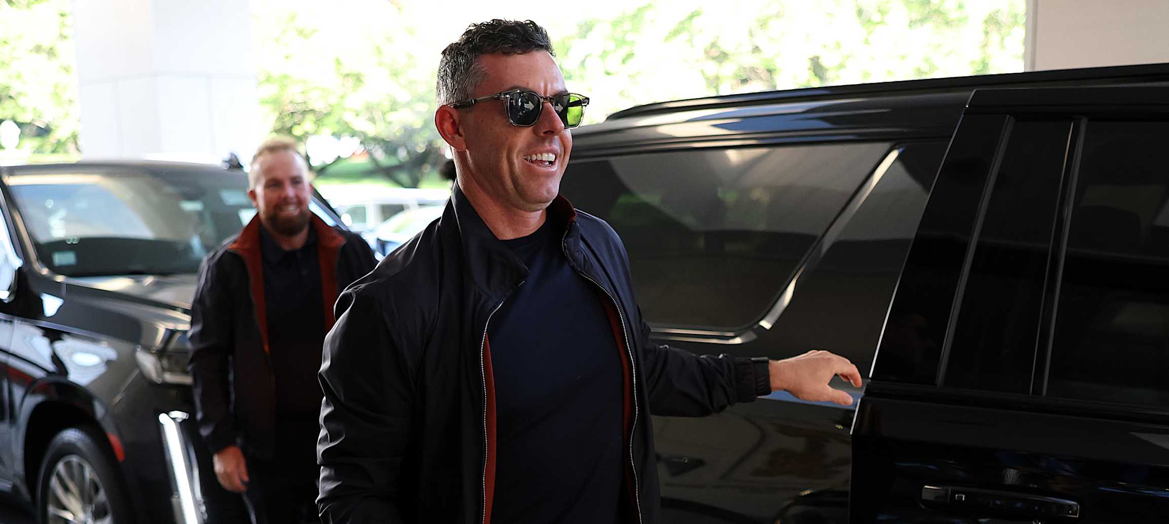 GARDEN CITY, NEW YORK - SEPTEMBER 21: Rory McIlroy and Shane Lowry (obscured) of Team Europe arrive prior to the Ryder Cup 2025 at Garden City Hotel on September 21, 2025 in Garden City, New York. (Photo by Richard Heathcote/Getty Images)