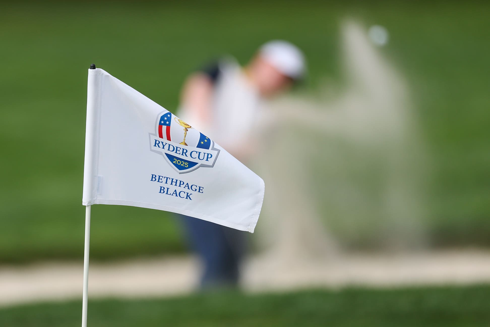 FARMINGDALE, NEW YORK - SEPTEMBER 22: A general view of a Ryder Cup flag as Robert MacIntyre of Team Europe practices bunker shots during a practice round prior to the Ryder Cup 2025 at Black Course at Bethpage State Park Golf Course on September 22, 2025 in Farmingdale, New York. (Photo by Carl Recine/Getty Images)