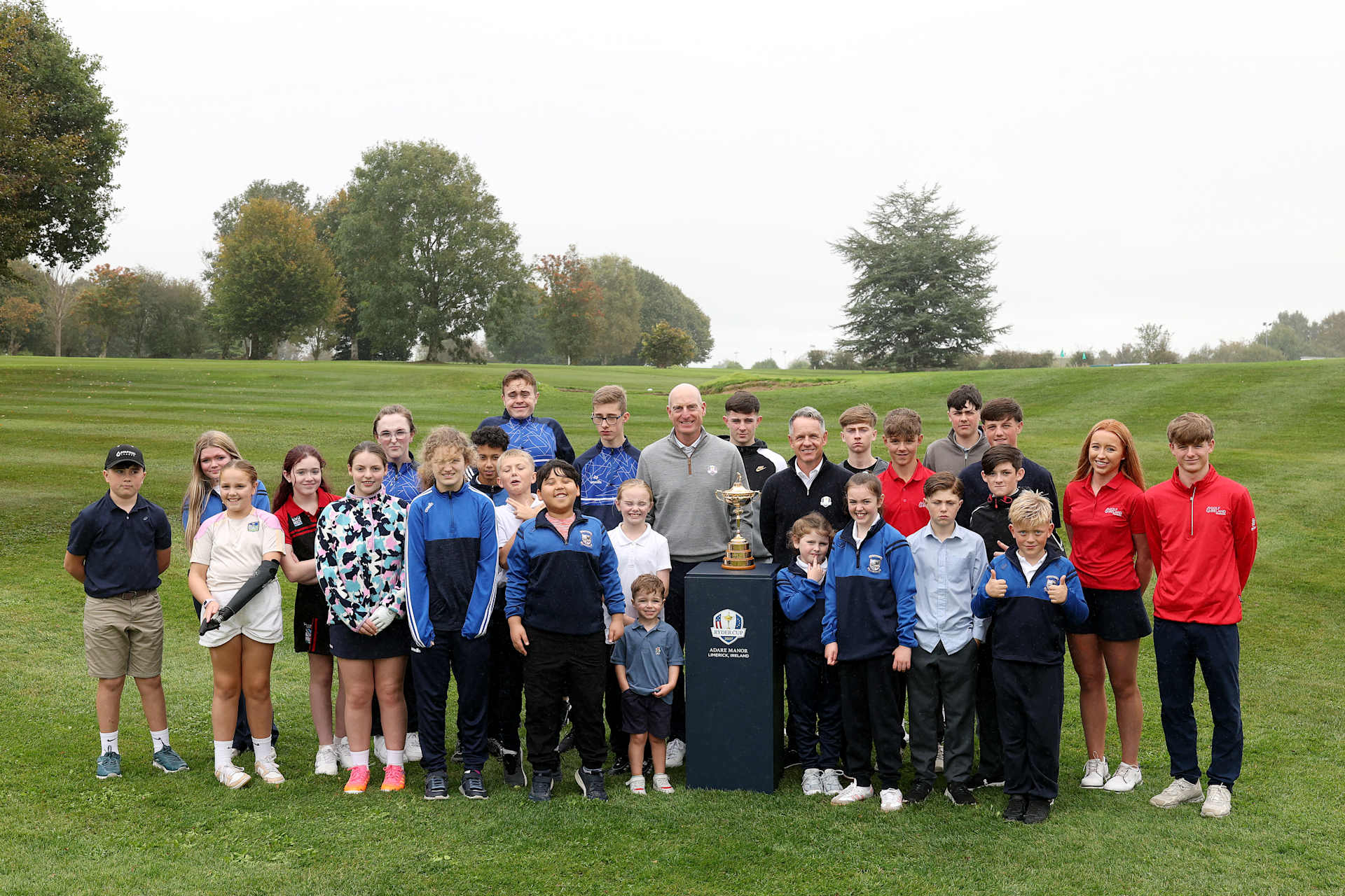 LAHINCH, IRELAND - OCTOBER 05: Jim Furyk, Team USA Captain,  and Luke Donald, Team Europe Captain, pose for a photo with members of the Junior Legacy Programme during the Ryder Cup 2027 Year to Go Junior Legacy Programme at Rathbane Golf Club on October 05, 2026 in Limerick, Ireland. (Photo by Andrew Redington/Getty Images)