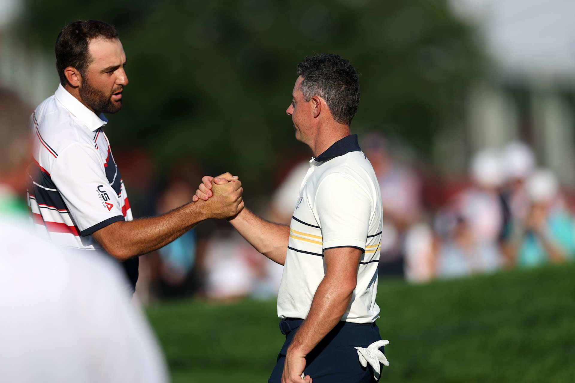 FARMINGDALE, NEW YORK - SEPTEMBER 28: (L-R) Scottie Scheffler of Team United States and Rory McIlroy of Team Europe shake hands after their match during the Sunday singles matches of the 2025 Ryder Cup at Black Course at Bethpage State Park Golf Course on September 28, 2025 in Farmingdale, New York. (Photo by Carl Recine/Getty Images)