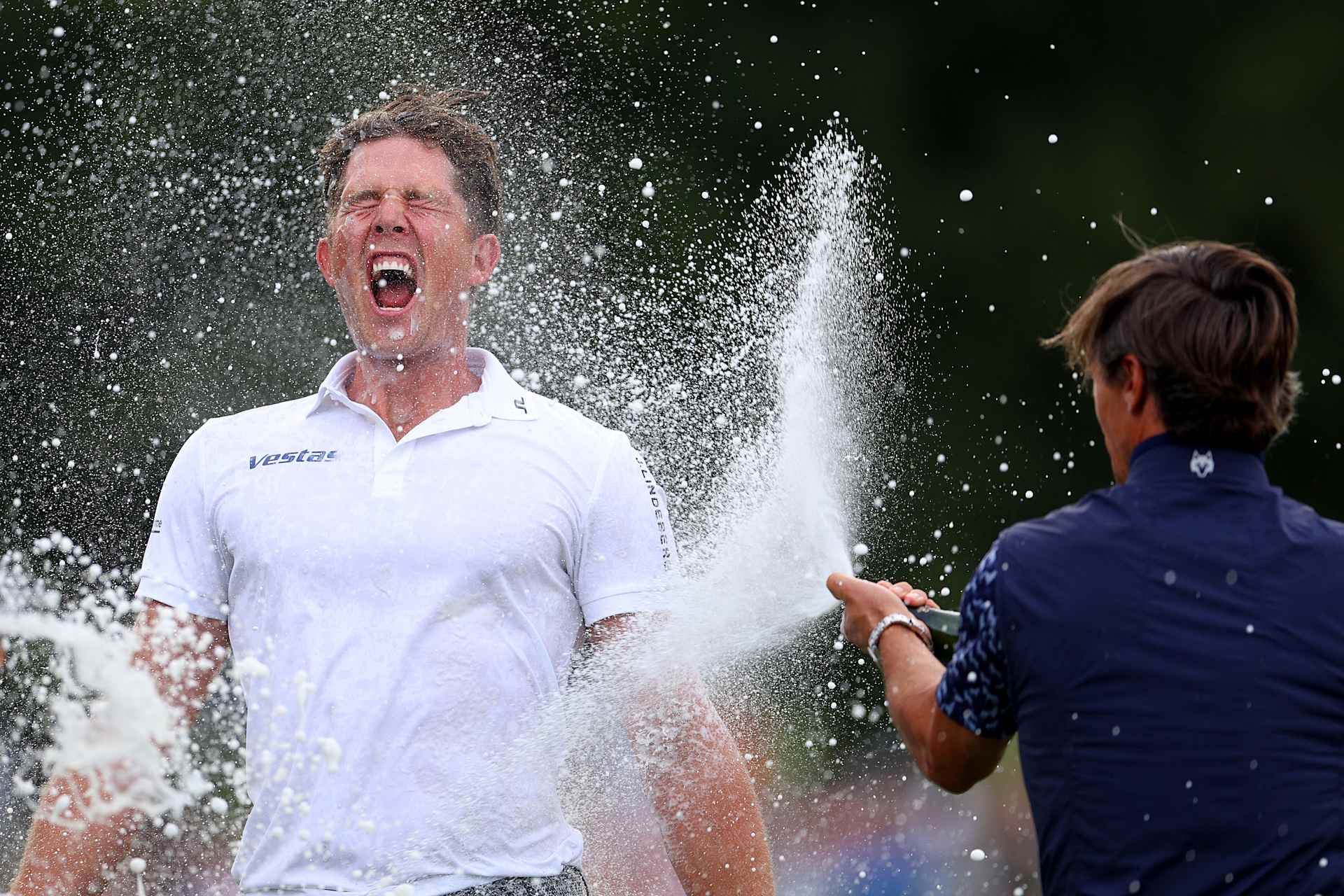 SUTTON COLDFIELD, ENGLAND - SEPTEMBER 01: Niklas Norgaard of Denmark has drink sprayed across him on the 18th green by Thorbjorn Olesen of Denmark following victory on Day Four of the Betfred British Masters hosted by Sir Nick Faldo at The Belfry on September 01, 2024 in Sutton Coldfield, England. (Photo by Andrew Redington/Getty Images)