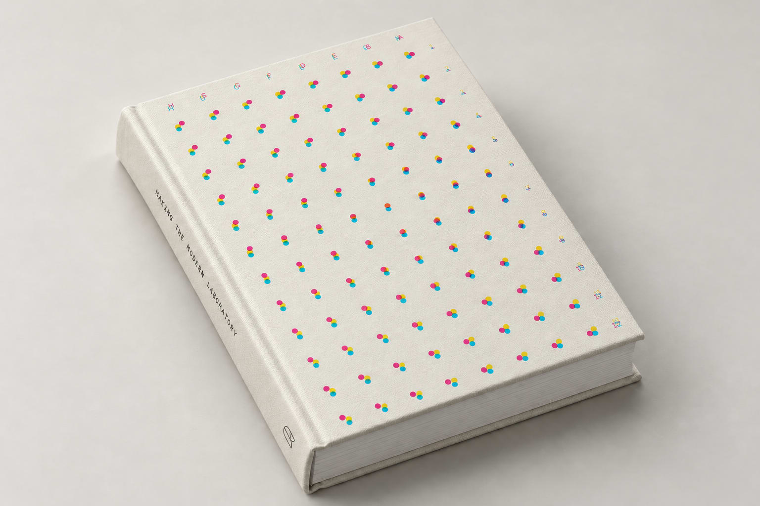 Making the Modern Laboratory hardcover book, with a cream cloth cover patterned with cyan, magenta, and yellow dots.
