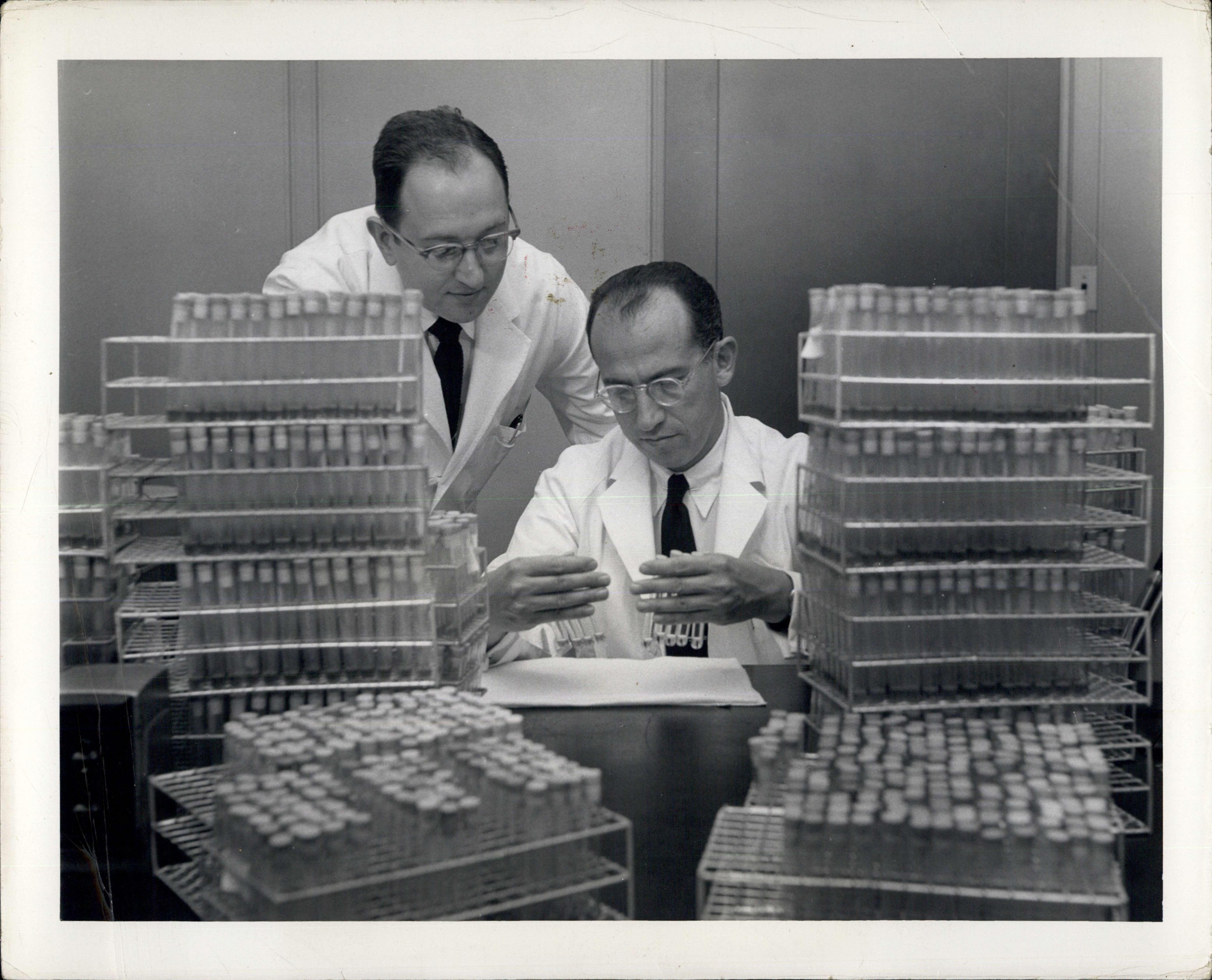 Jonas Salk in his Virus Research Laboratory in 1954 with assistant J.S. Youngner.