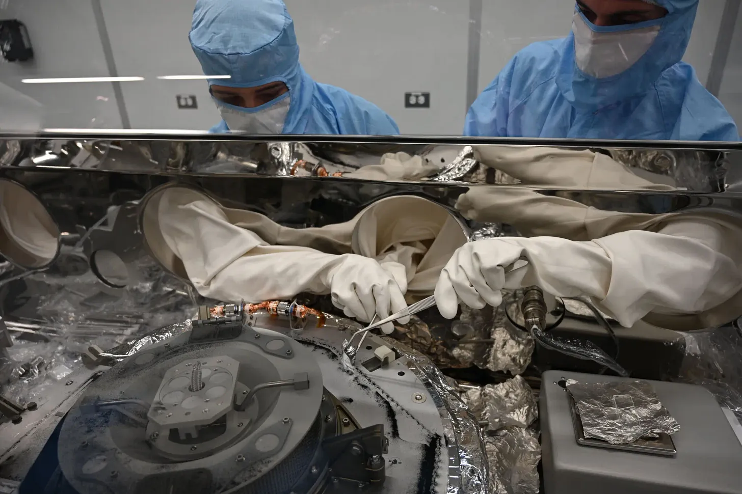 Scientists open up the OSIRIS-REx robotic probe to collect the asteroid samples inside.