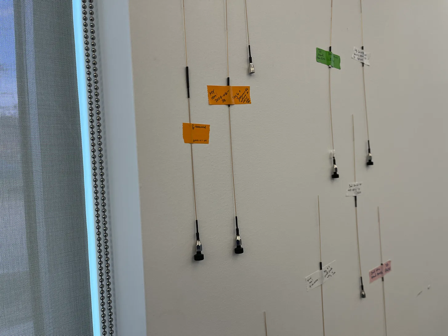 Used column emitters taped to a wall in the PTI laboratory.