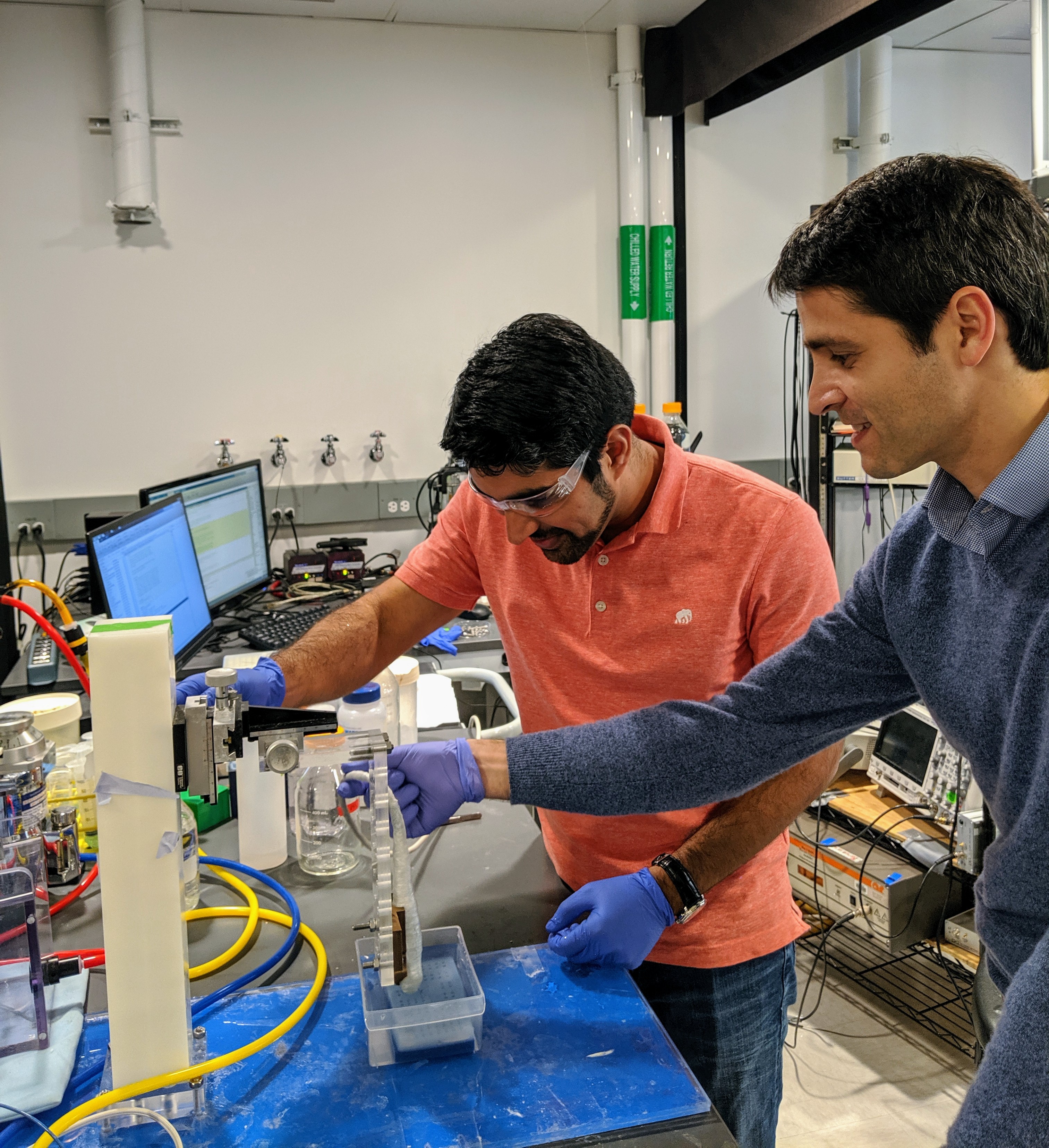 Arash Farhadi and Mikhail Shapiro setting up an ultrasound experiment in their Caltech laboratory.