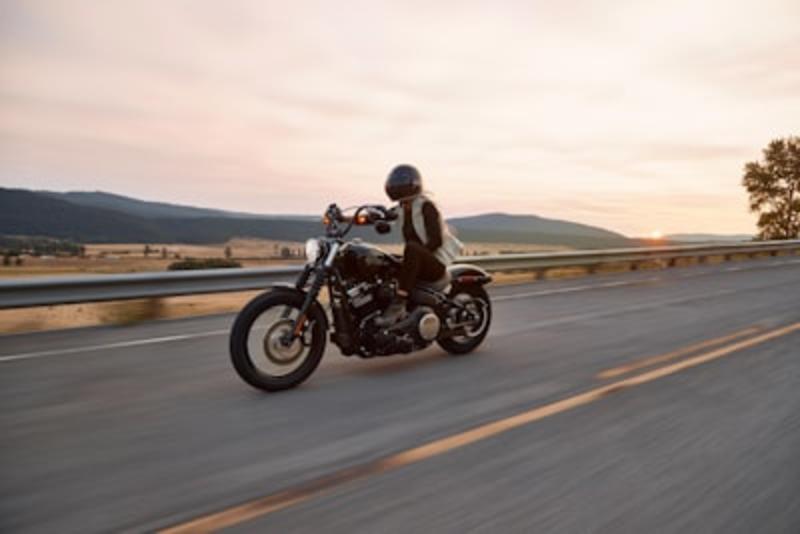 Motorcyclist looking over scenic mountain valley