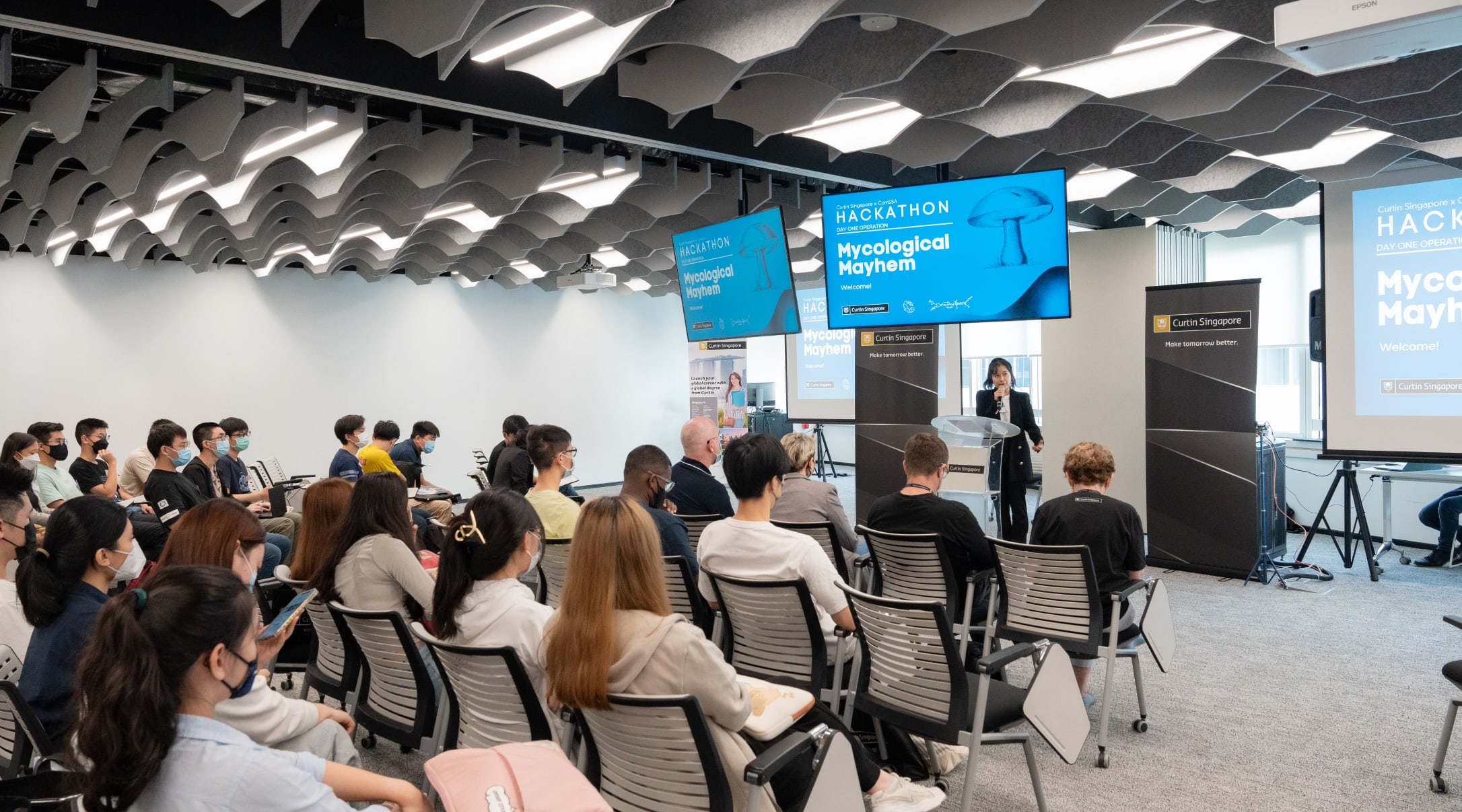 Wide shot of students listening