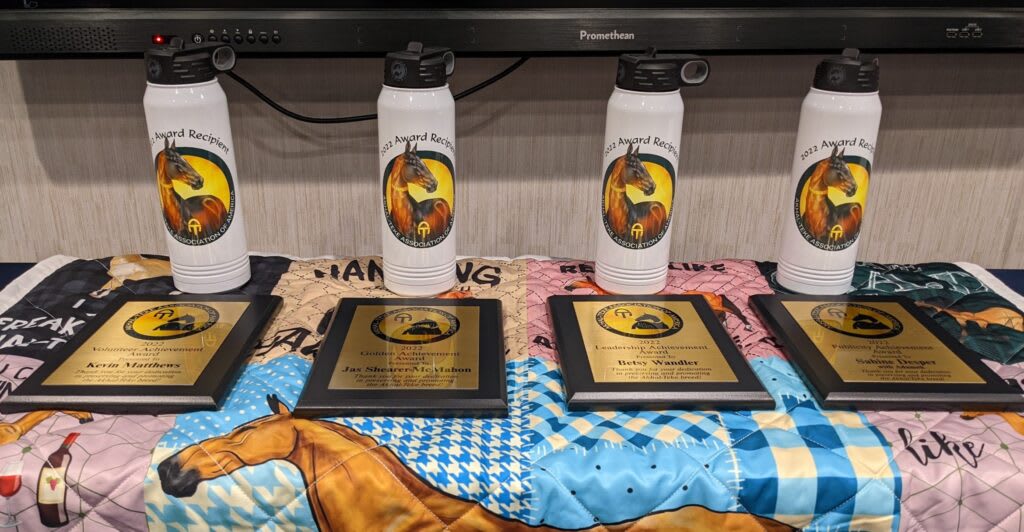 ATAA award plaques and embroidered prizes laid out on a table