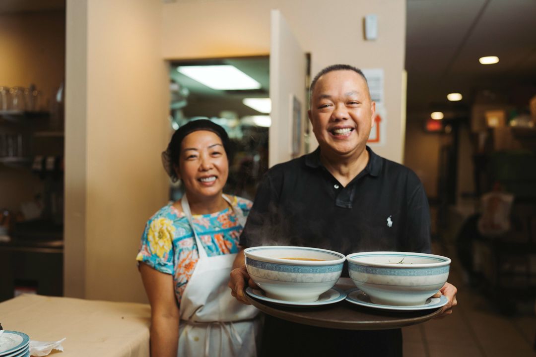 Pho Cali owners serving bowls of pho in downtown Sarasota.