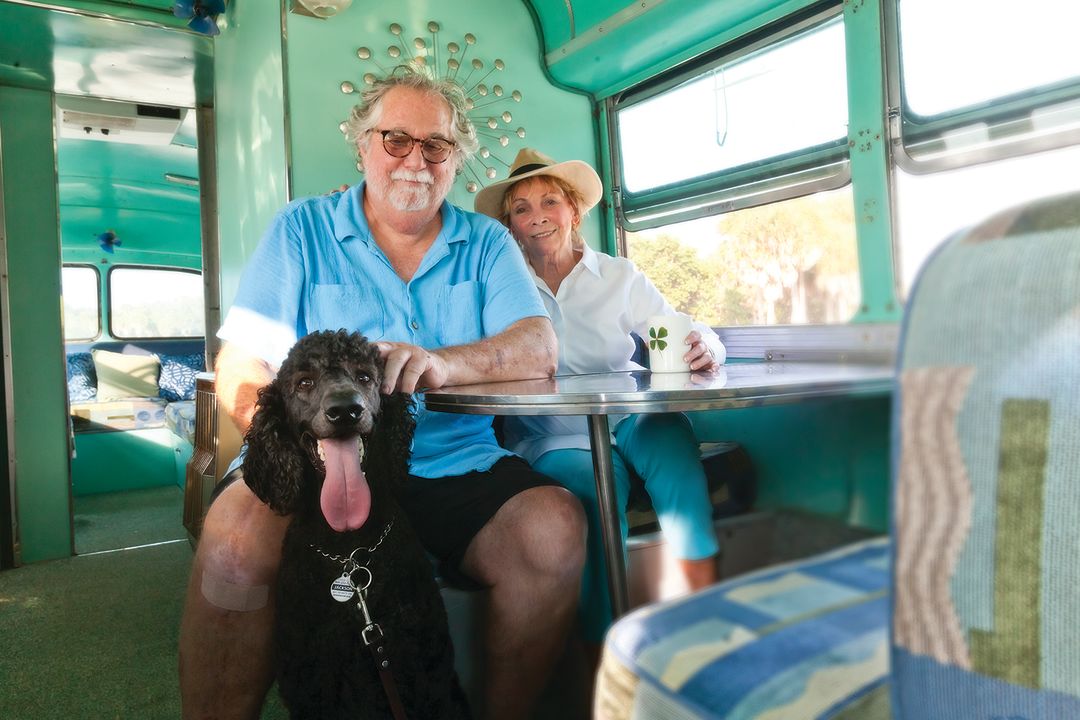 Bob and Danee Barnett with their standard poodle, Jack, in their vintage motorcoach.