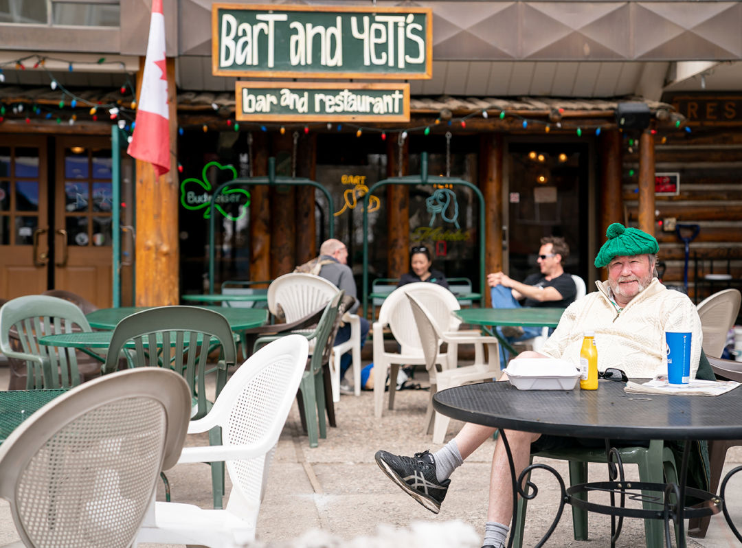 A person sitting on the Bart and Yeti's outdoor patio in Lionshead Village