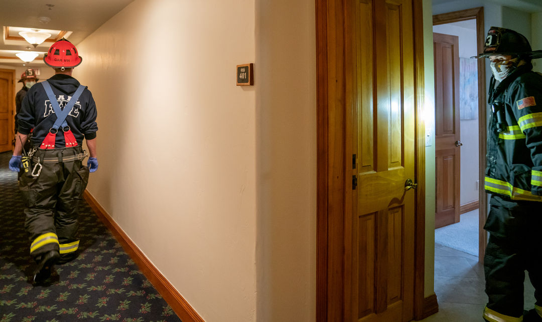 Firefighters in a condo hallway