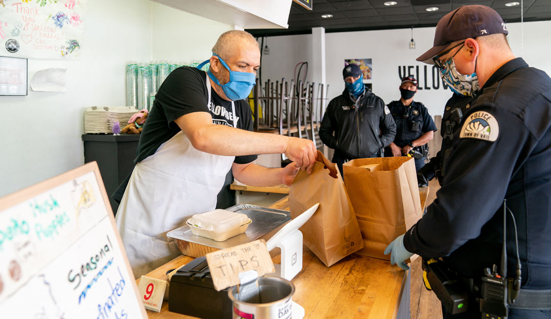 Police officers purchase food at a restaurant in Vail