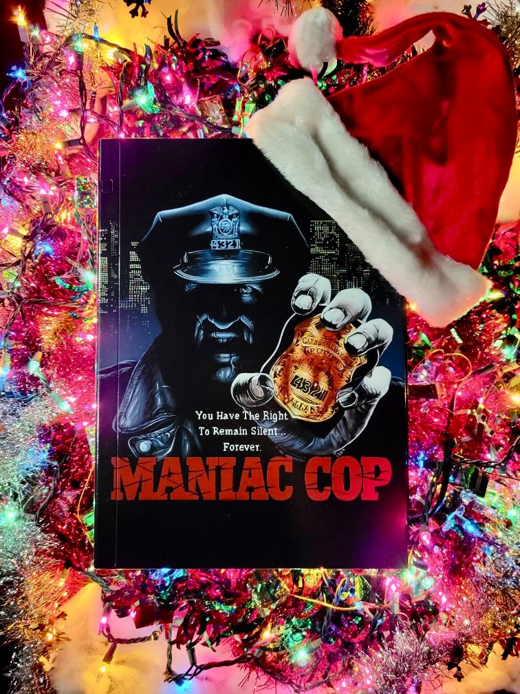 maniac cop DVD case hanging on a Christmas tree with a Santa hat on the corner