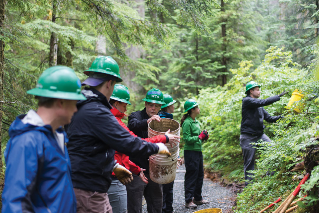 Teamwork on a washington trails association work party at franklin falls. photo by erik haugen goodman lq2dzd