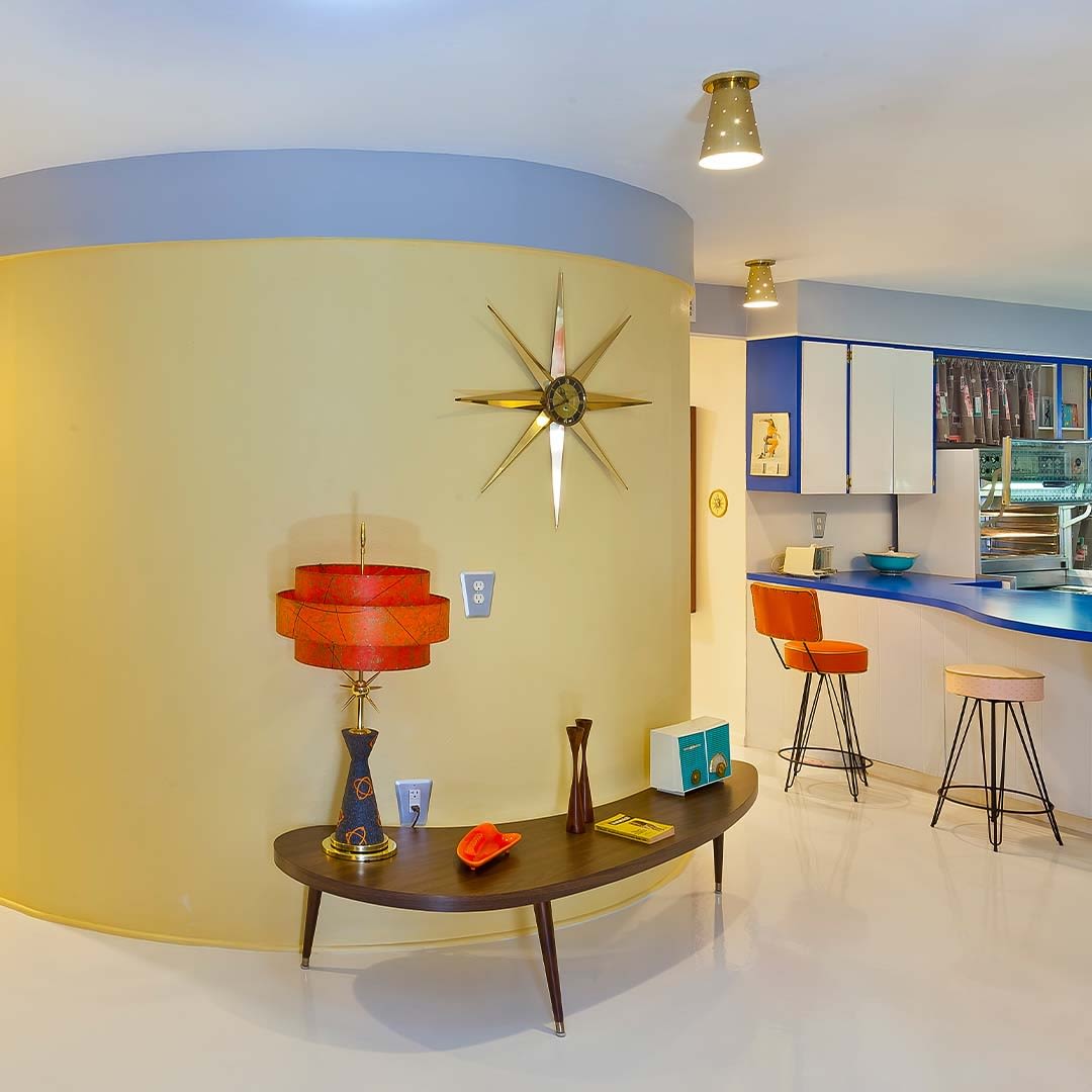 Inside a round house that is finished in midcentury modern style.