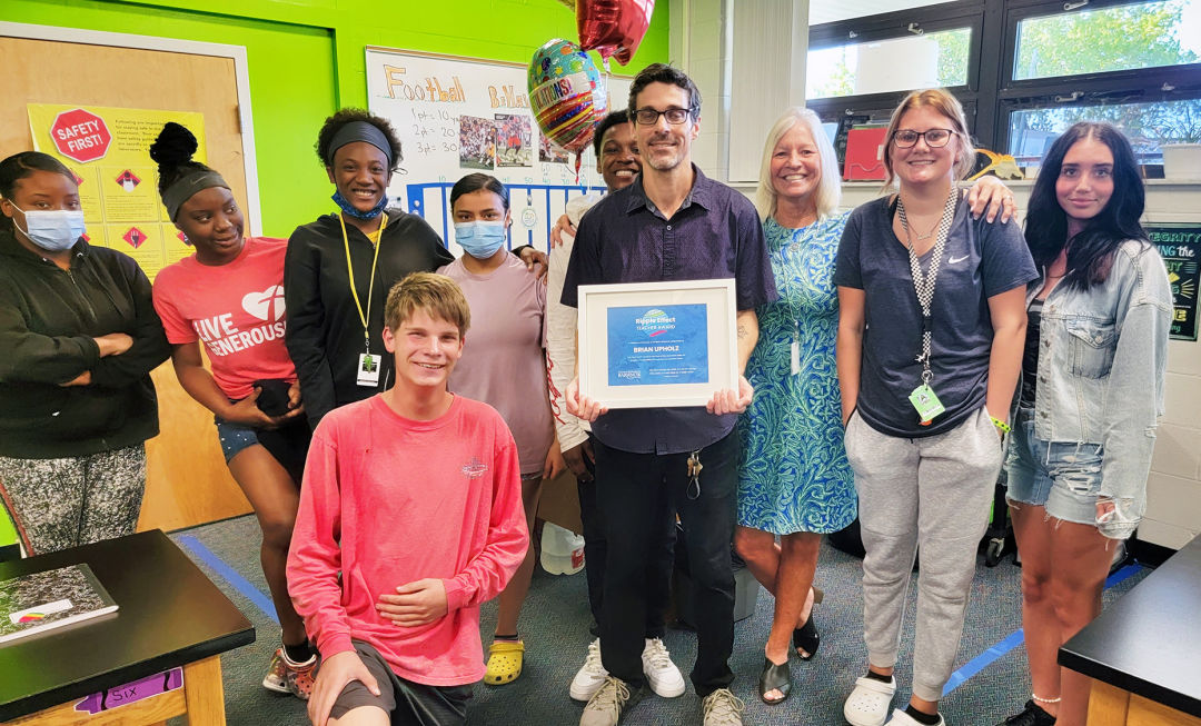 Brian Upholz, Ripple Award recipient, with Melanie Ritter, director of Triad, and students