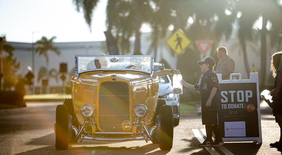 Little boy collects donations at Sarasota Cars & Coffee.