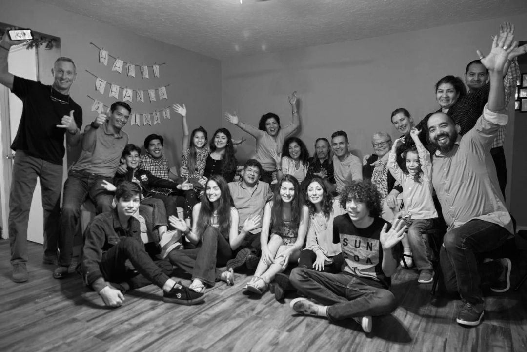 Enrique Pino and his extended family posing for a group picture in celebration