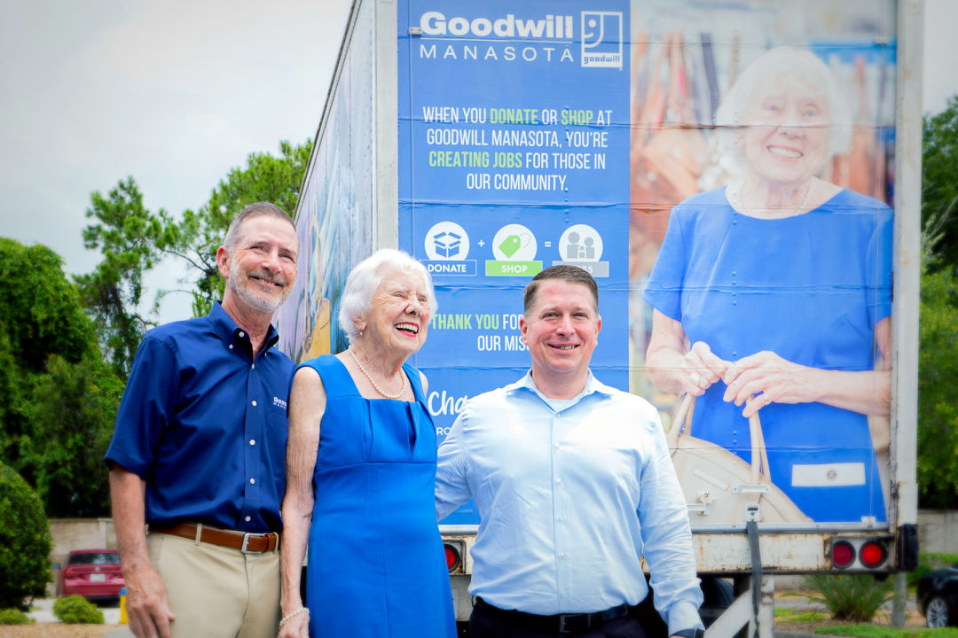 Goodwill Manasota president and CEO Bob Rosinsky, longtime volunteer Jo Rita Stevens, and vice-president of operations Donn Githens during the unveiling of Jo Rita's' truck.