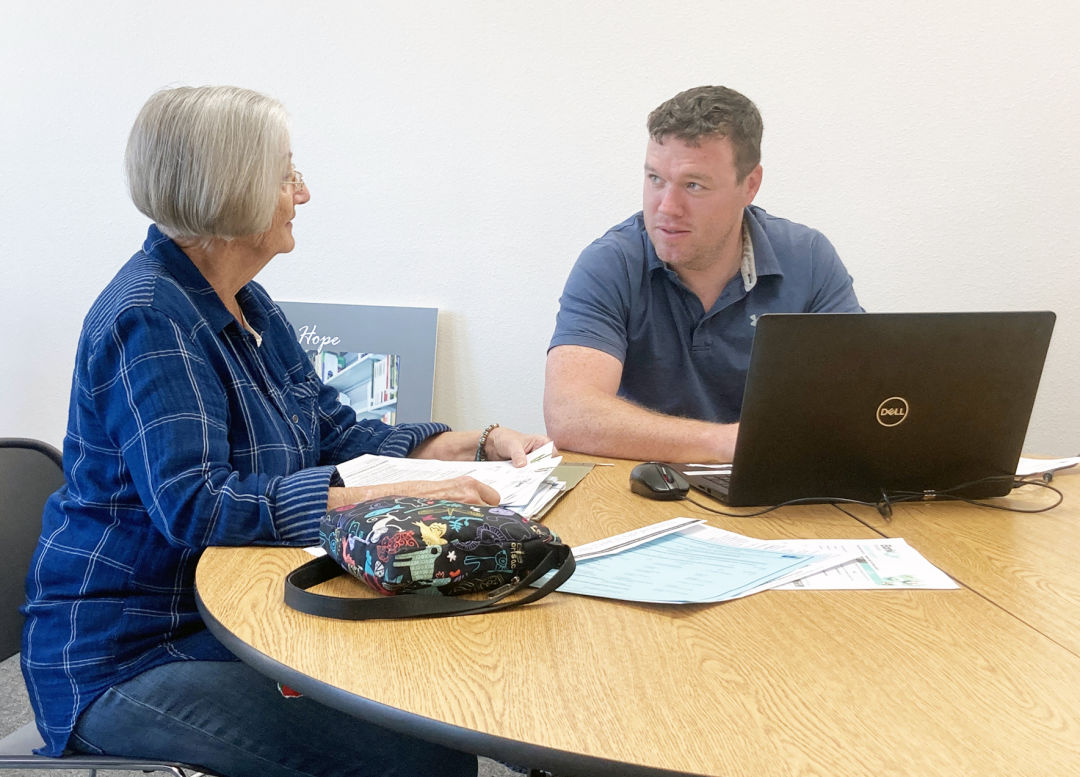 VITA volunteer Nathan Reneau assists a community member with her taxes at Goodwill’s north Sarasota location